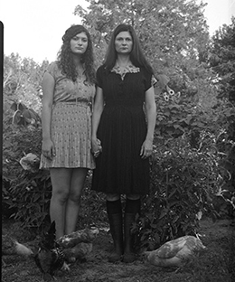 Maxine Payne, right, in her garden with chickens and her daughter, Clementine Ophelia.  Photo by Donna Pinckley. 