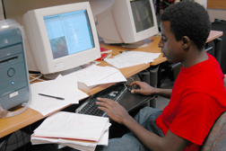 Rukundo uses a computer to calculate the lifespan of a muon, a short-lived particle produced in earth's atmosphere.