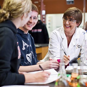 Chemistry professor and students performing an experiment.
