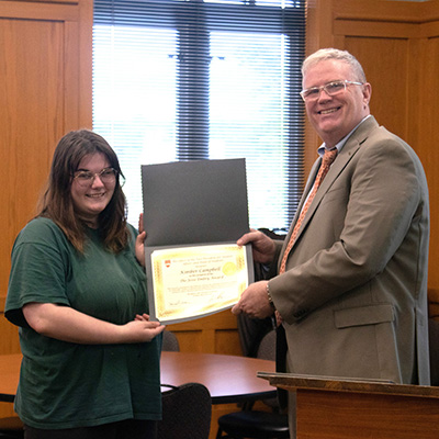 Kimber Campbell receives the Jessie Embry Award from Dean Jim Wiltgen.