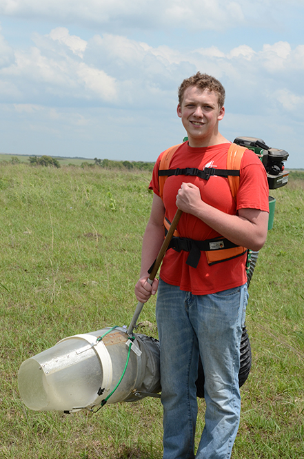 Zach Nickell ’17 uses a D-vac machine to sample arthropods in an Oklahoma prairie.